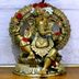 Tr Residency Pondicherry image of a brass Ganesha statue with floral garlands and umbrella canopy