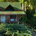 Aguila de Osa Rainforest Lodge in Agujitas de Drake, jungle lodge with green roof and porch