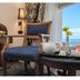 Cherry Maryski Hotel Alexandria room with sea view, chair, table and tea set by the window