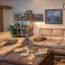 Cypress Fairway Village in Wimberley: living room with beige leather sofas, coffee table, lamps and wall art