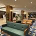 Kakogawa Plaza Hotel lobby lounge with teal sofa, tan chairs, and geometric tile floor in Kakogawa