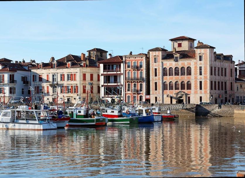 Hôtel La Marisa in Saint-Jean-de-Luz overlooking a harbor with boats and waterfront buildings