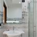 Hotel Mediterraneo in Porto Cesareo bathroom with glass shower, sink, and wall mirror