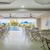 Howard Johnson by Wyndham Barranquilla Versalles terrace dining area with pool view in Barranquilla