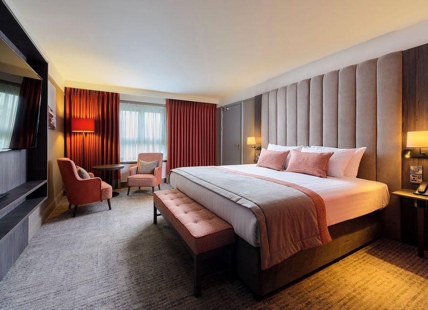 Hotel Killarney, Killarney guest room with king bed, seating area, and large window