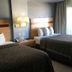Arya Blu Inn and Suites, Ormond Beach guest room with two double beds and bedside lamp