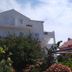 Apartments Antonio in Cavtat with white balconies and lush garden in front of the building