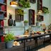 Leonardo Hotel Madrid City Center breakfast buffet with fruit, pastries and hanging lights in Madrid