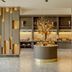 Buenos Aires Ezeiza Airport Marriott lobby with gold-accented wall panels and central display table in Buenos Aires