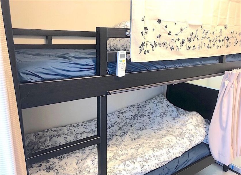 Tokyo Art House in Tokyo with black bunk beds and floral bedding in a compact guest room