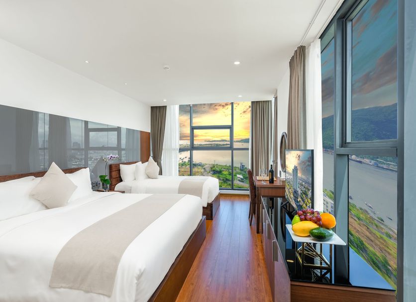 Alan Sea Hotel Danang guest room with twin beds and floor-to-ceiling ocean and city views in Da Nang