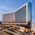 Loews Arlington Hotel in Arlington exterior with modern glass facade at dusk