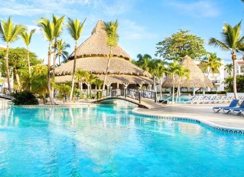 Be Live Experience Hamaca Suites in Boca Chica with a tropical pool and thatched-roof palapas