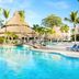 Be Live Experience Hamaca Suites in Boca Chica with a tropical pool and thatched-roof palapas