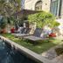 La Maison Grivolas in Avignon, courtyard pool with loungers, umbrella and stone hotel facade