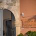 Vecchio Hotel in Rethymno entrance with stone archway and wooden hotel sign