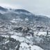 Lecadin Hotel in Karpenísi overlooking a snowy mountain town and valley