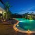 Gending Kedis Luxury Villas & Spa Estate in South Kuta, illuminated outdoor infinity pool at dusk