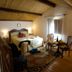 Residence Palazzo Baldi in Galatina: cozy guest room with double bed, wood ceiling, and seating area