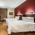 Red Roof Plus Long Island - Garden City guest room in Westbury with two beds, desk and TV