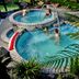 Taupo Debretts Spa Resort in Taupo with outdoor pools and guests soaking in thermal water