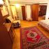 Hotel Sporting in Breuil-Cervinia: cozy guest room with bed, armchair, wood wardrobe and red rug