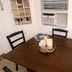 La Mare Fort Lauderdale Airport room with dining table, chairs, window AC and wall shelves in Fort Lauderdale