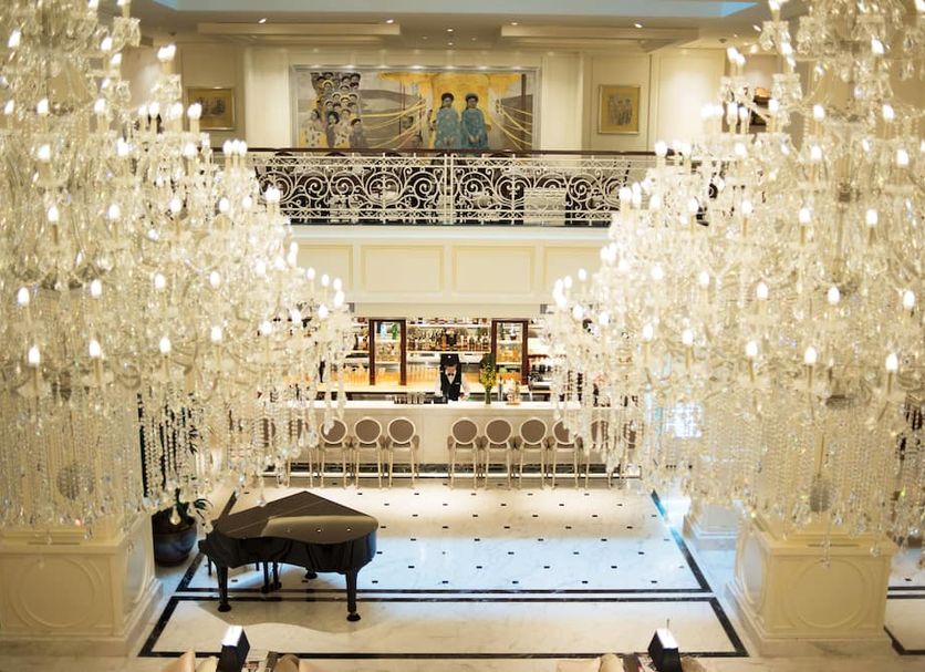 Apricot Hotel Hanoi grand lobby with crystal chandeliers, piano and elegant bar area