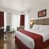 Ramada Encore by Wyndham Bangalore Domlur guest room with king bed, desk, chair, and city-view windows in Bengaluru