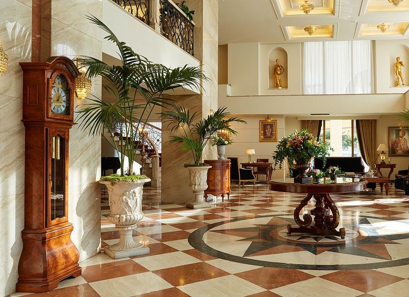 Mediterranean Palace Thessaloniki lobby with grand atrium, marble floor, and ornate clock