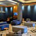 Minas Garden Hotel lobby lounge in Poços de Caldas with modern seating and dark walls