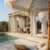 Umm Al Quwain Beach Hotel poolside cabana with daybed, outdoor dining area and curtains in Umm Al Qaiwain