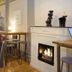Grand Hotell Hörnan in Uppsala lounge with lit fireplace, bar stools, tables and red armchairs