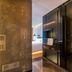 Puruihotel Yongkang in Jinhua: modern hotel room entrance with glass wardrobe and backlit bed area