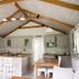 The Anchorage & The Tackleshed, Barry: bright kitchen with vaulted wooden ceiling, island, and dining table