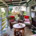 Hale Kawehi Bnb Guesthouse in Hilo porch seating area with wicker chairs and garden view