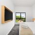 Yha Brisbane City room with wall-mounted TV, bed, and city view through window in Brisbane