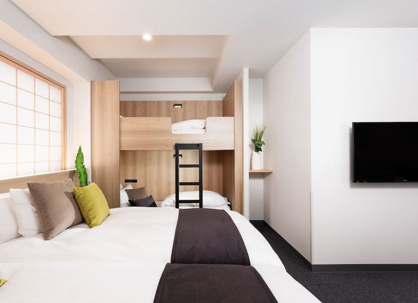 Mimaru Tokyo Ueno Okachimachi room with bunk beds, white bedding, and wall-mounted TV in Tokyo