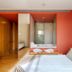 Hotel Balneari Prats room with bed, open bathroom and warm wood closet in Caldes de Malavella