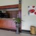 RedDoorz @ Seturan Raya 2 in Depok lobby bar with wooden counter and potted plants