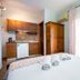 Famelia Studios Lampiris in Potos, studio room with kitchenette, wardrobe and balcony doors