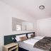 Hotel International am Theater in Münster room with twin beds, wall mirror and minimalist white decor