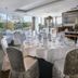Moyvalley Hotel & Golf Resort banquet room with round tables, white chair covers, and garden views
