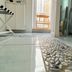 Vingt Sept in Polignano a Mare bathroom with pebble-style tile strip and glass shower