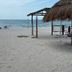 Hotel San Julio in Celestún: beachside palapa shelter with ocean view and sandy shoreline