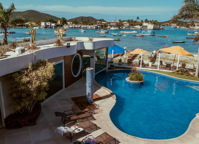 Hotel Paradiso del Sol in Cabo Frio with oceanfront pool, loungers, and bay views