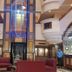 Hotel The Taksonz lobby in Ludhiana with modern seating and a glass elevator shaft