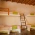 La Casa de Sebas, Máncora: rustic dorm room with four beds and a central ladder