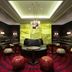 Hilton Kyiv lounge with low seating, round stools, and dramatic backlit green feature wall in Kyiv