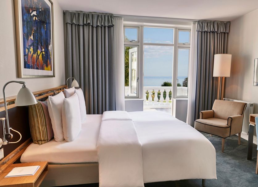 Kurhotel Skodsborg room in Copenhagen with twin beds, balcony door, and sea view